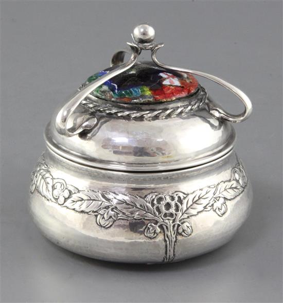 An Edwardian Arts & Crafts planished silver and enamel circular box and cover by Ramsden and Carr, height 11.5cm.